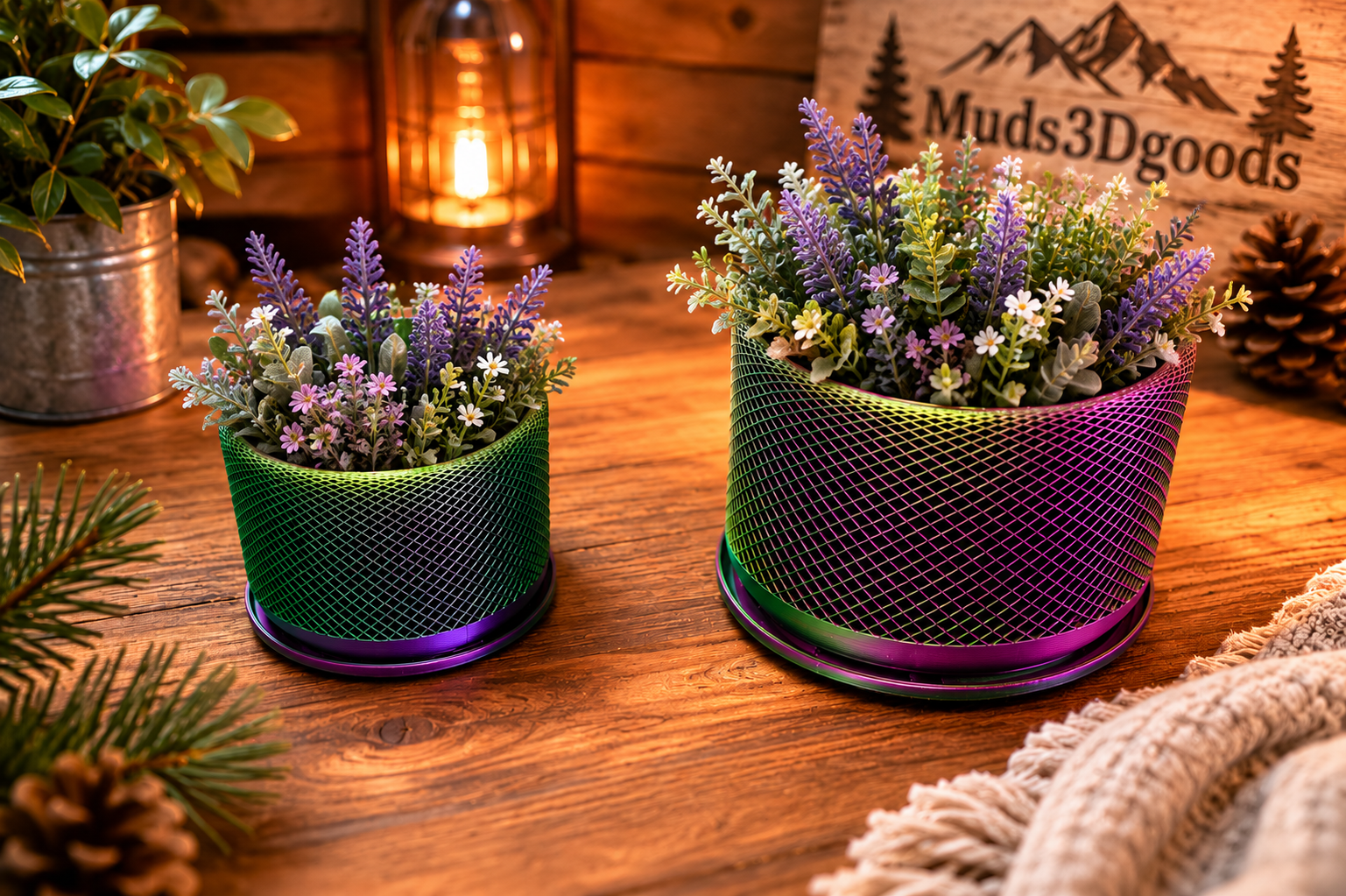 Two mesh planters with flowers on a wooden surface, featuring 'Muds3Dgoods' branding.